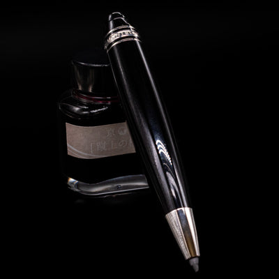 Montblanc Meisterstuck Leonardo Black & Platinum Sketch Pencil - Preowned leaning on an ink bottle.