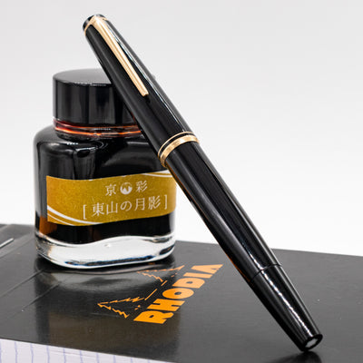 Capped Montblanc No. 24 black fountain pen with gold clip and trim resting on Rhodia notebook – preowned vintage pen in excellent condition
