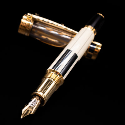 Montblanc Patron of Art Henry Steinway 888 Fountain Pen laying across its own cap, crossed, with a focus on the nib.