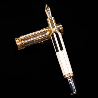 Montblanc Patron of Art Henry Steinway 888 Fountain Pen laying on top of its cap in a crossed position showing full view of the entire uncapped pen.