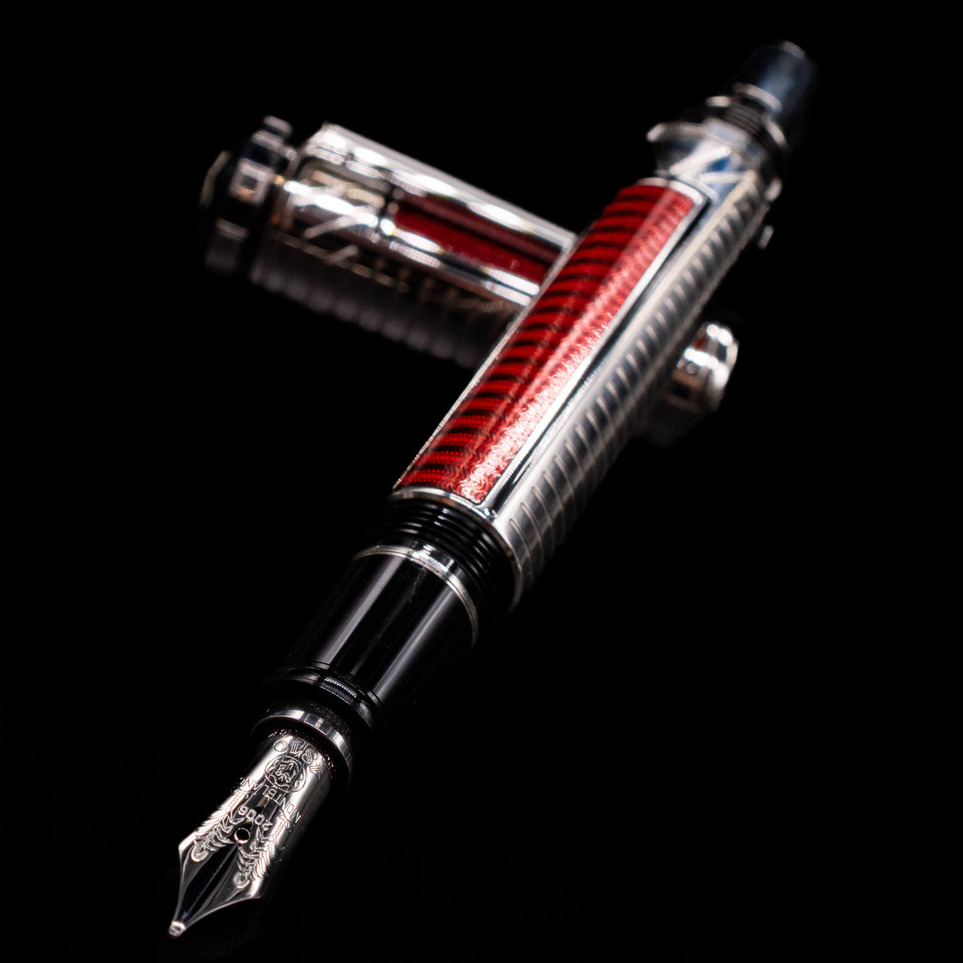 Montblanc Patron of Art Sir Henry Tate 4810 Fountain Pen - Preowned laying across its own cap, crossed, with a focus on the nib.