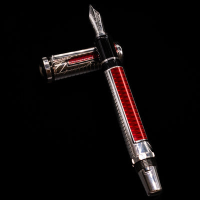 Montblanc Patron of Art Sir Henry Tate 4810 Fountain Pen - Preowned laying on top of its cap in a crossed position showing full view of the entire uncapped pen.