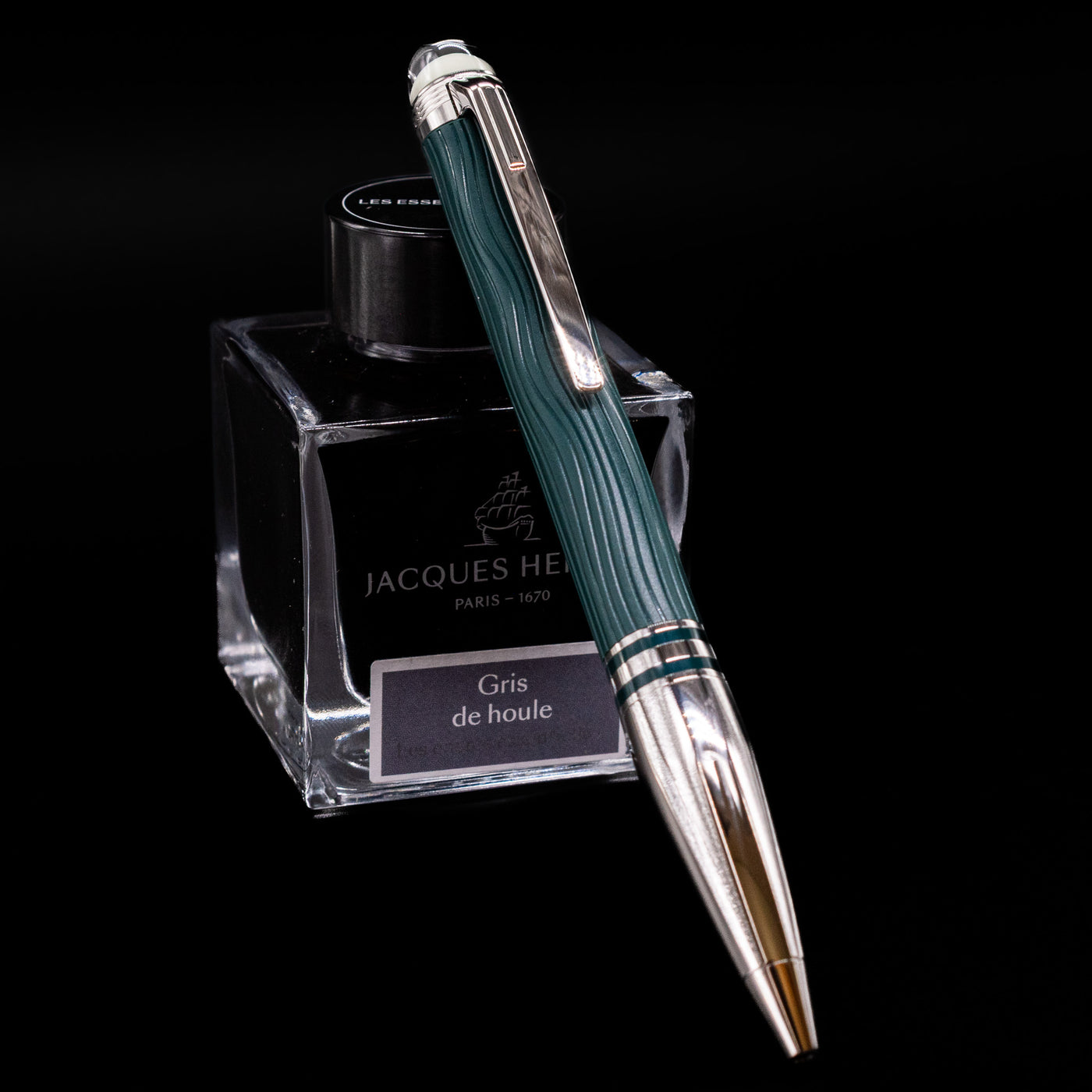 Montblanc Starwalker Doue Ballpoint Pen - Polar Green leaning on a bottle.