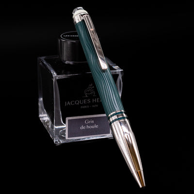 Montblanc Starwalker Doue Ballpoint Pen - Polar Green leaning on a bottle.