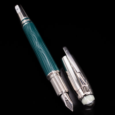  A full view of the Montblanc Starwalker Doue Fountain Pen - Polar Green uncapped, with its cap laying next to the pen. 