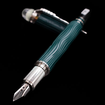 Montblanc Starwalker Resin Fountain Pen - Polar Green laying across its own cap, crossed, with a focus on the nib.