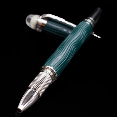 Montblanc Starwalker Resin Rollerball Fineliner Pen - Polar Green laying across its own cap, crossed, with a focus on the tip.