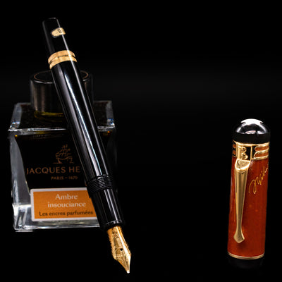 Montblanc Writer's Edition 2000 Friedrich Schiller Fountain Pen - Preowned leaning on an ink bottle uncapped showcasing the detailing on the nib.