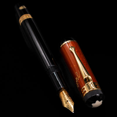  A full view of the Montblanc Writer's Edition 2000 Friedrich Schiller Fountain Pen - Preowned uncapped, with its cap laying next to the pen. 