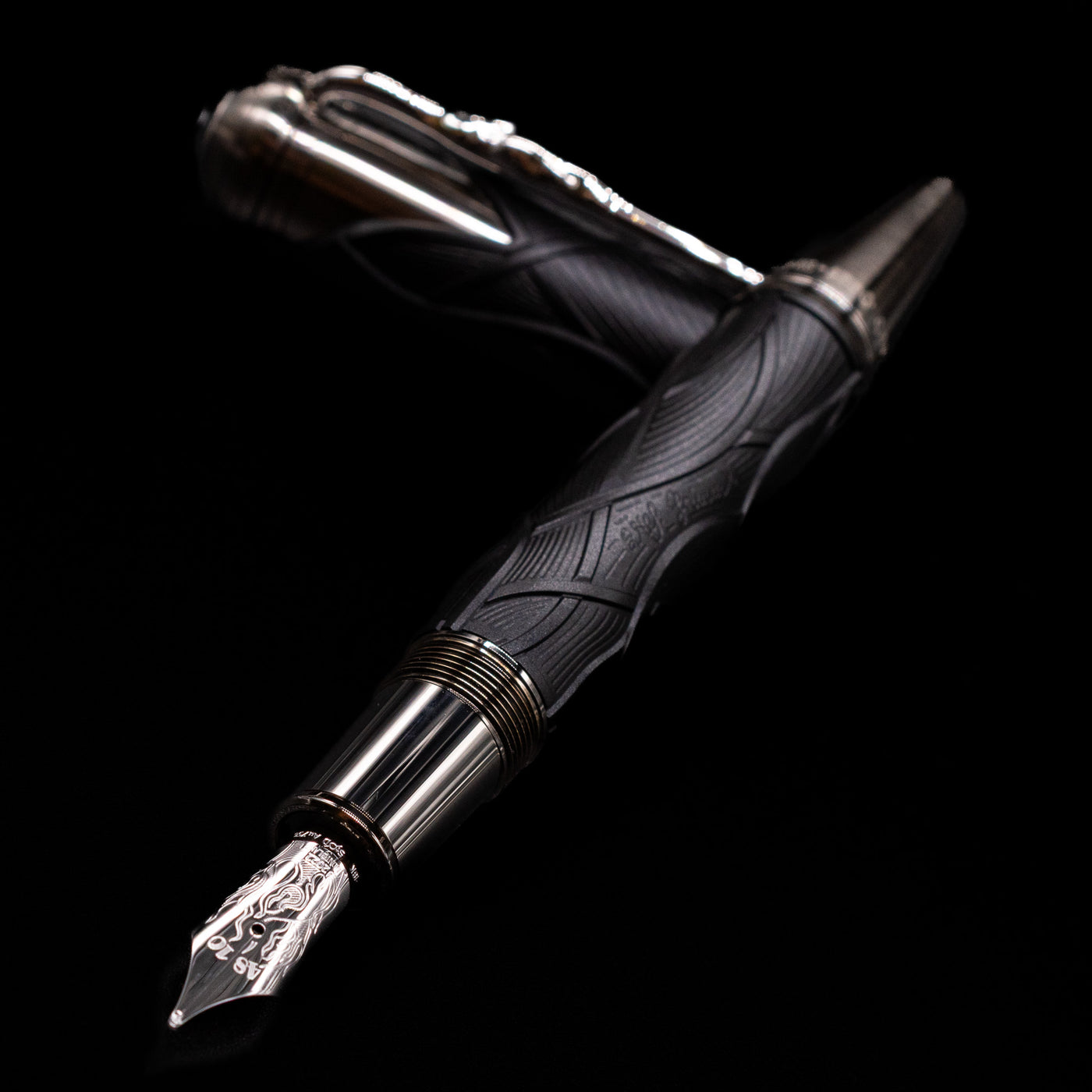 Montblanc Writer's Edition Brothers Grimm Fountain Pen laying across its own cap, crossed, with a focus on the nib.