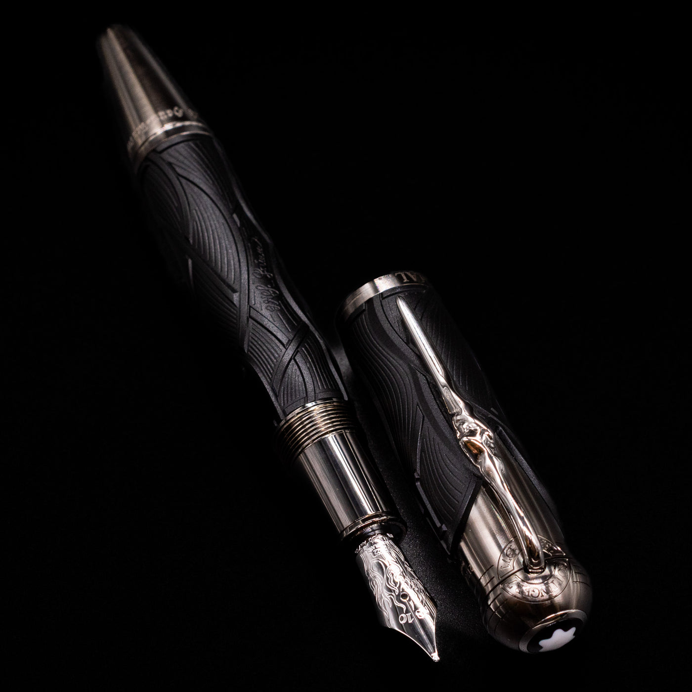 A full view of the Montblanc Writer's Edition Brothers Grimm Fountain Pen uncapped, with its cap laying next to the pen. 