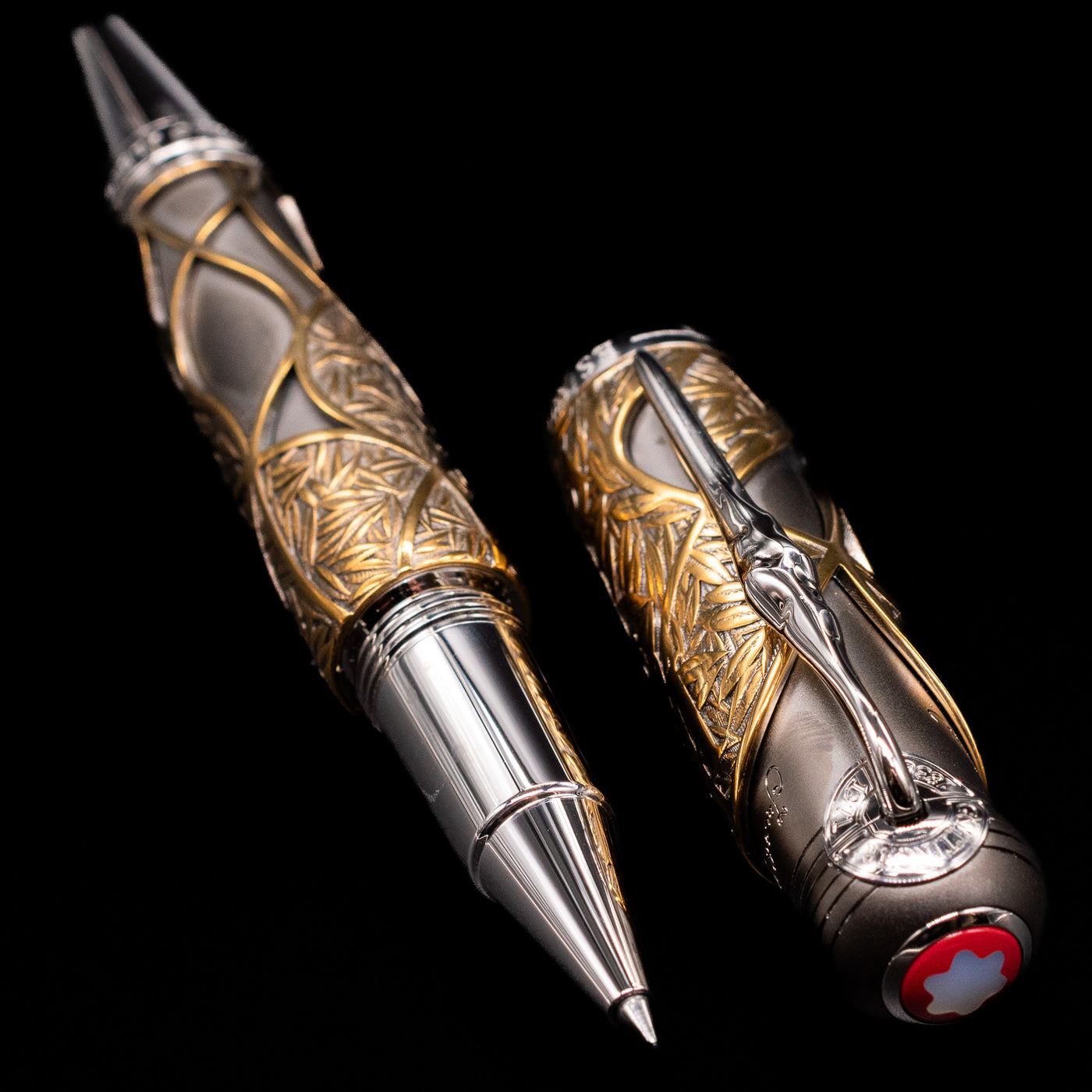  A full view of the Montblanc Writer's Edition Brothers Grimm Limited Edition 1812 Rollerball Pen - Preowned uncapped, with its cap laying next to the pen.