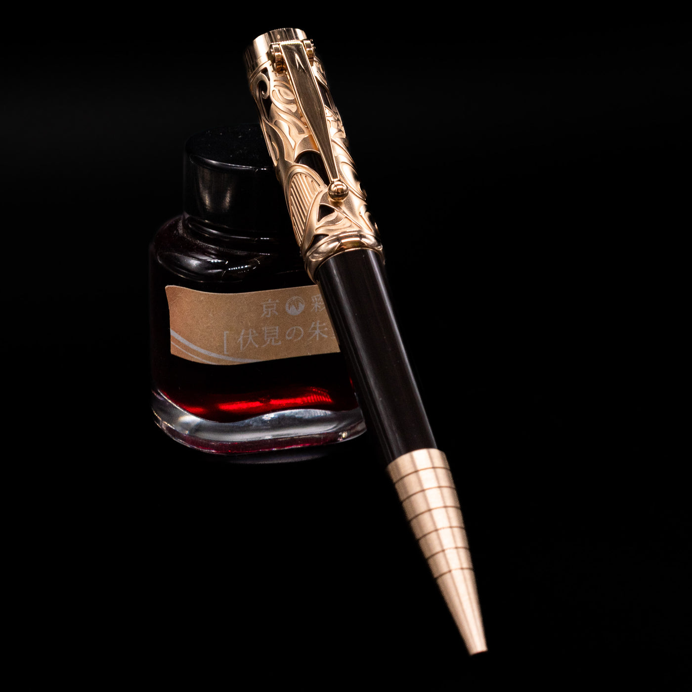 Montblanc Writer's Edition Carlo Collodi Ballpoint Pen - Preowned leaning on an ink bottle.