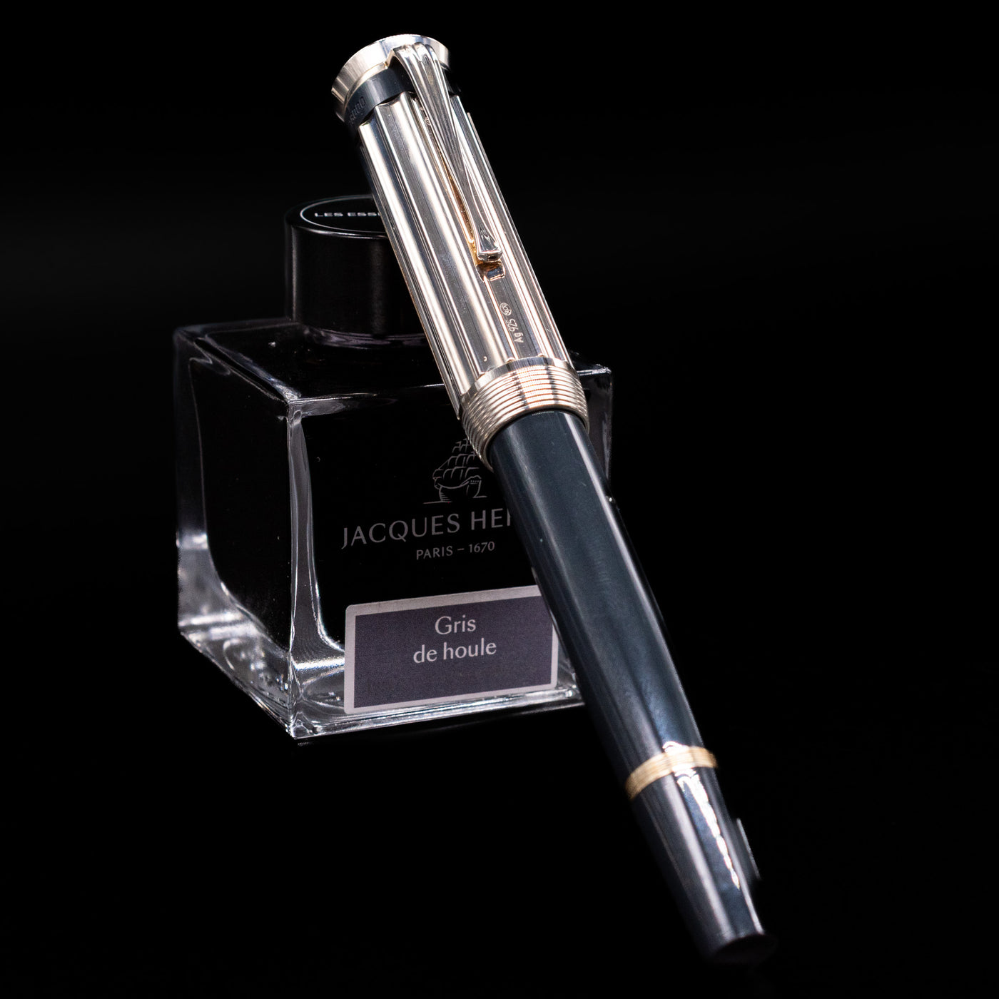 Montblanc Writer's Edition Charles Dickens Fountain Pen - Preowned capped, leaning against an ink bottle.