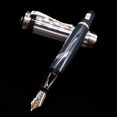 Montblanc Writer's Edition Charles Dickens Fountain Pen - Preowned laying across its own cap, crossed, with a focus on the nib.