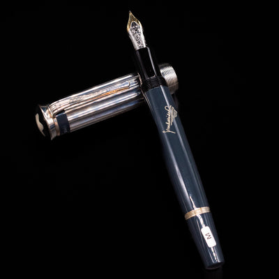 Montblanc Writer's Edition Charles Dickens Fountain Pen - Preowned laying on top of its cap in a crossed position showing full view of the entire uncapped pen.
