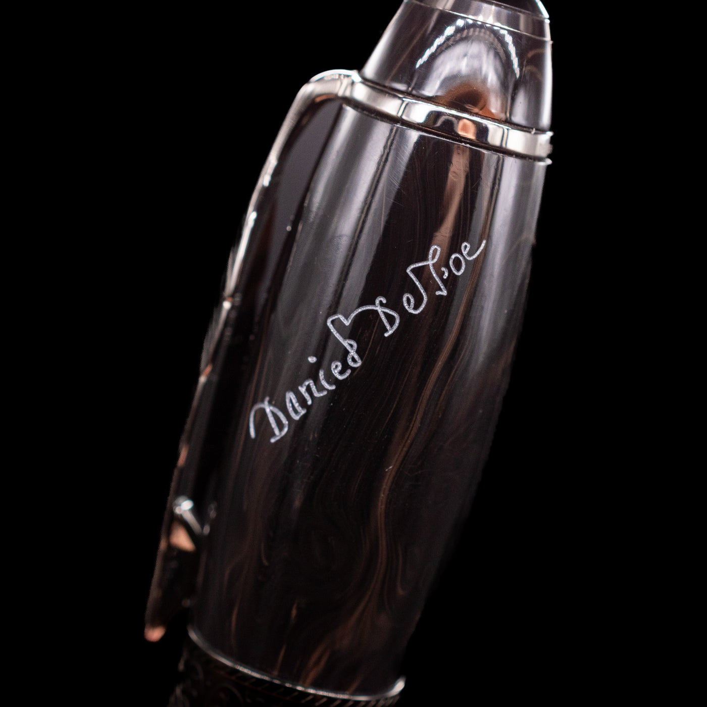 A macro shot of the writer's signature on the barrel of the Montblanc Writer's Edition Daniel Defoe Ballpoint Pen - Preowned.