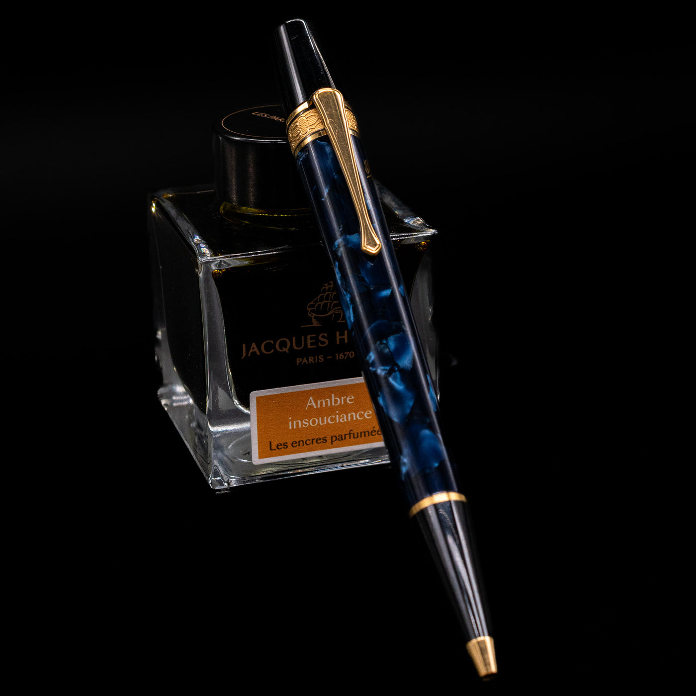 Montblanc Writer's Edition Edgar Allan Poe Ballpoint Pen - Preowned leaning on an ink bottle.