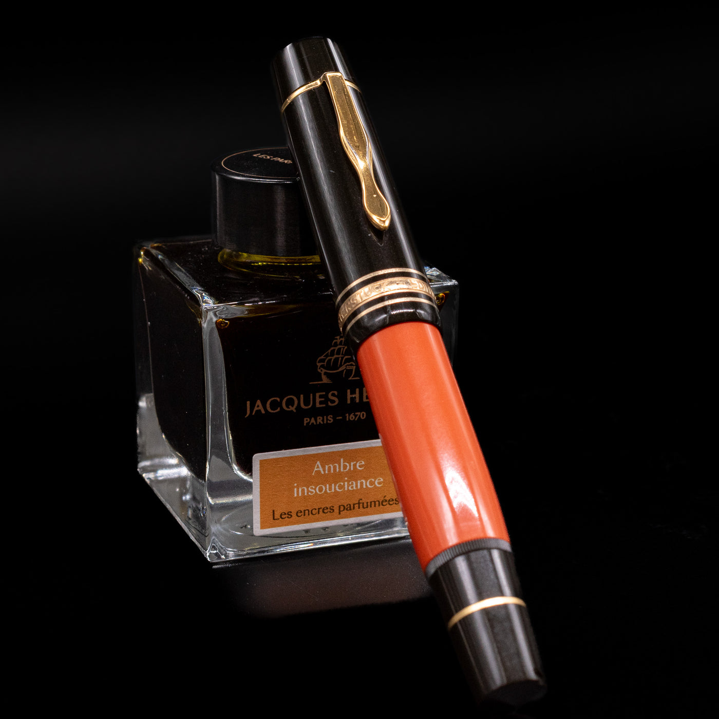 Montblanc Writer's Edition Ernest Hemingway Fountain Pen - Preowned capped, leaning against an ink bottle. 