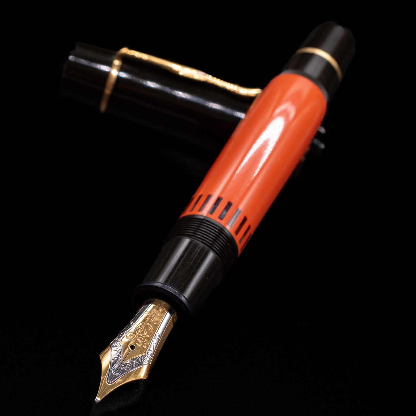 Montblanc Writer's Edition Ernest Hemingway Fountain Pen - Preowned laying across its own cap, crossed, with a focus on the nib.