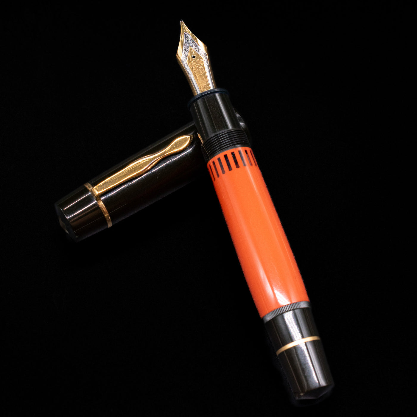 Montblanc Writer's Edition Ernest Hemingway Fountain Pen - Preowned laying on top of its cap in a crossed position showing full view of the entire uncapped pen.
