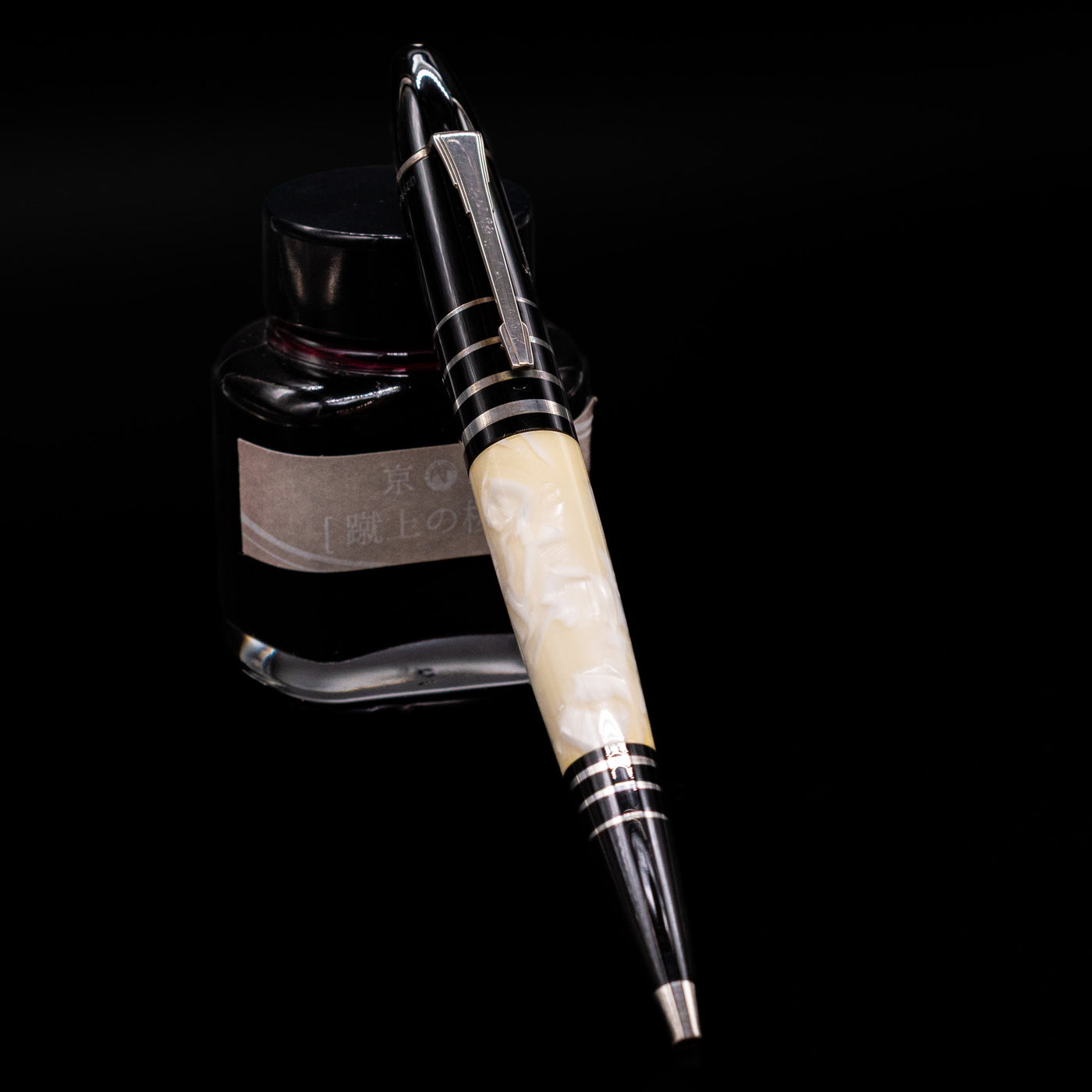 Montblanc Writer's Edition F Scott Fitzgerald Ballpoint Pen - Preowned leaning on an ink bottle.