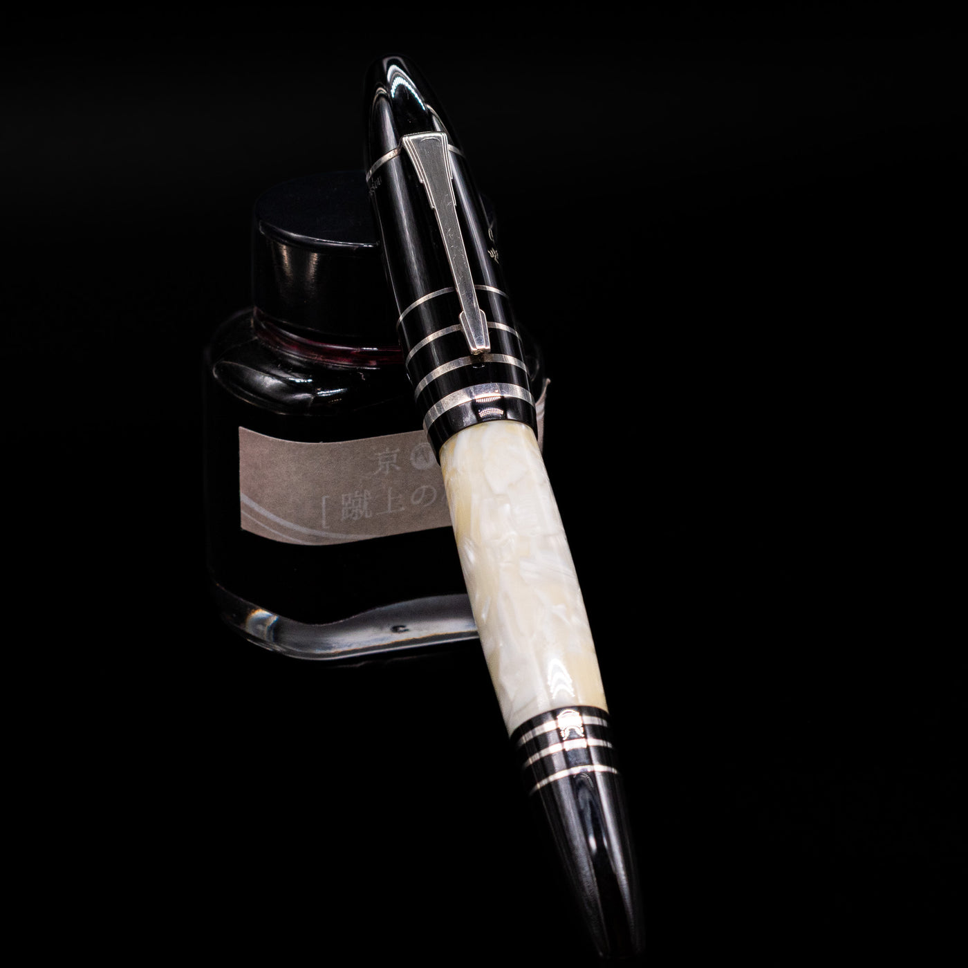 Montblanc Writer's Edition F. Scott Fitzgerald Fountain Pen - Preowned  capped, leaning against an ink bottle. 