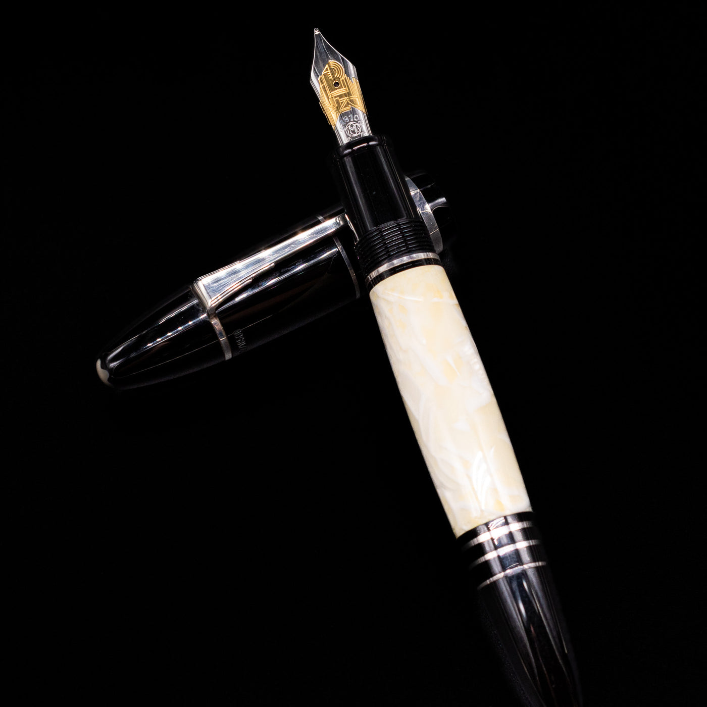 Montblanc Writer's Edition F. Scott Fitzgerald Fountain Pen - Preowned  laying on top of its cap in a crossed position showing full view of the entire uncapped pen.
