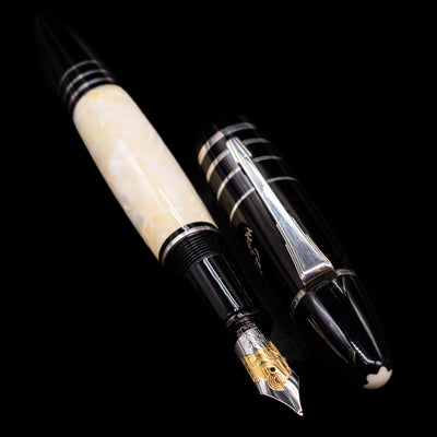 A full view of the Montblanc Writer's Edition F. Scott Fitzgerald Fountain Pen - Preowned uncapped, with its cap laying next to the pen. 