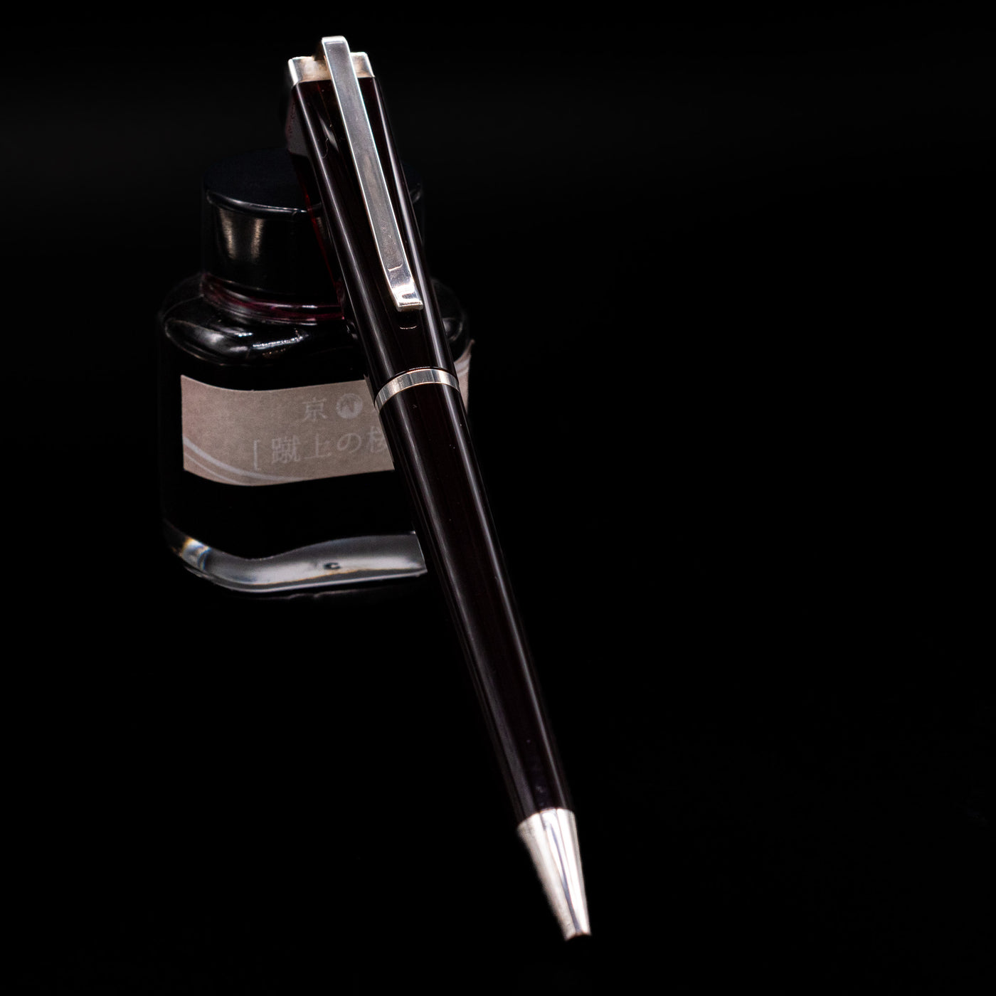 Montblanc Writer's Edition Franz Kafka Ballpoint Pen - Preowned leaning on an ink bottle.