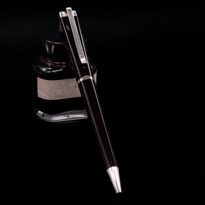 Montblanc Writer's Edition Franz Kafka Ballpoint Pen - Preowned leaning on an ink bottle.