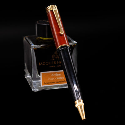Montblanc Writer's Edition Friedrich Schiller Ballpoint Pen - Preowned leaning against an ink bottle.