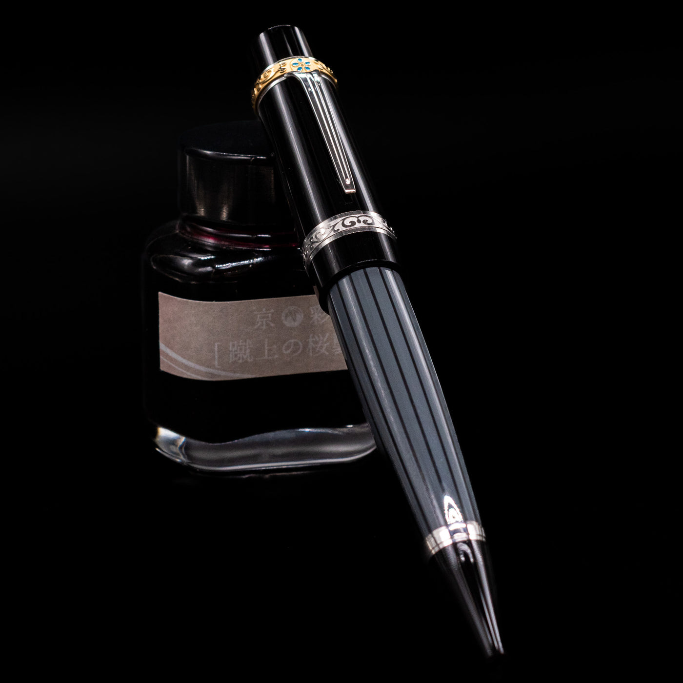 Montblanc Writer's Edition Honore de Balzac Ballpoint Pen - Preowned leaning against an ink bottle.