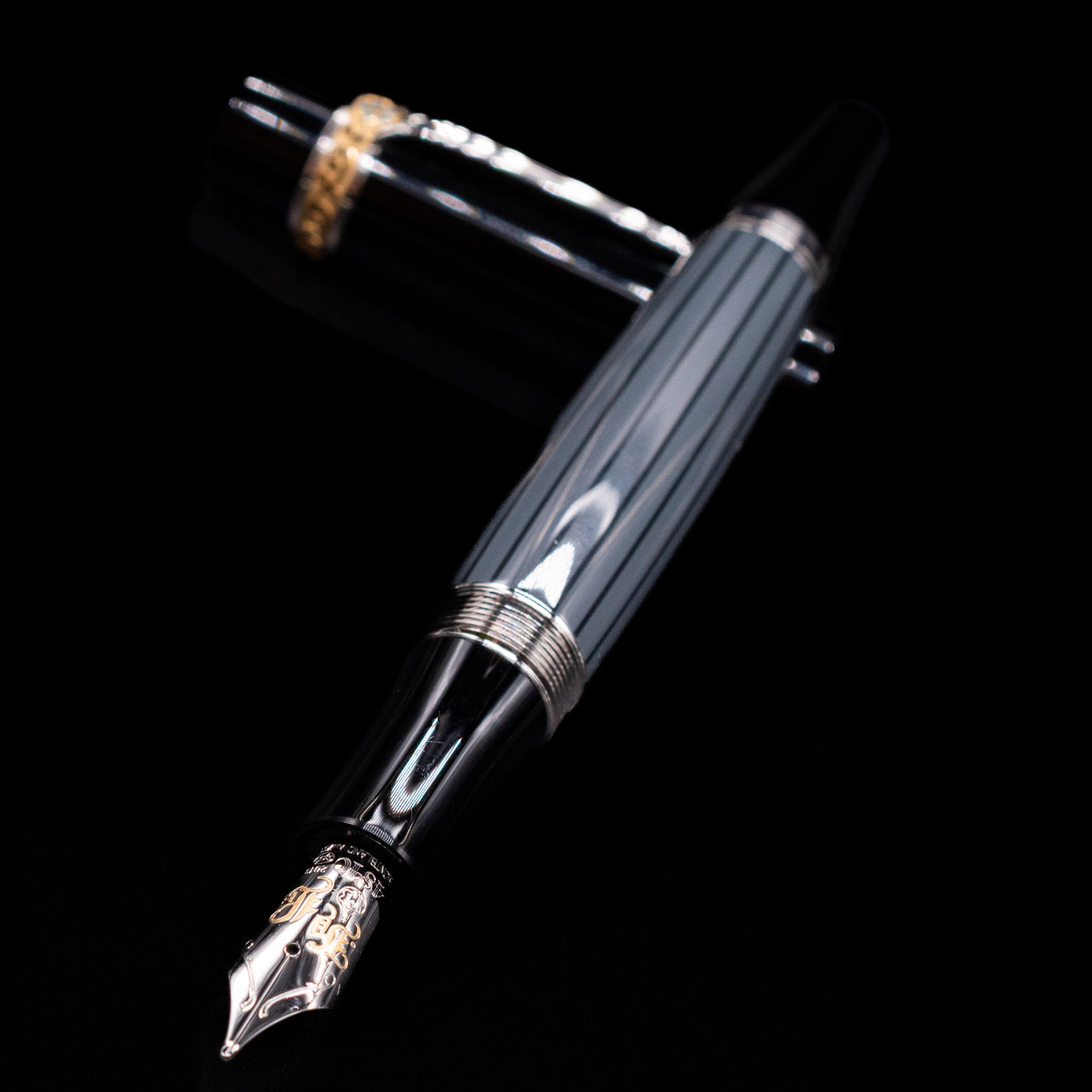 Montblanc Writer's Edition Honore de Balzac Fountain Pen - Preowned laying across its own cap, crossed, with a focus on the nib.