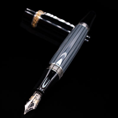 Montblanc Writer's Edition Honore de Balzac Fountain Pen - Preowned laying across its own cap, crossed, with a focus on the nib.