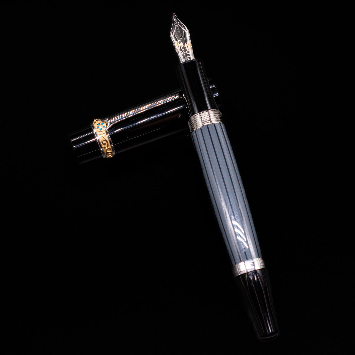 Montblanc Writer's Edition Honore de Balzac Fountain Pen - Preowned laying on top of its cap in a crossed position showing full view of the entire uncapped pen.