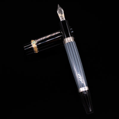 Montblanc Writer's Edition Honore de Balzac Fountain Pen - Preowned laying on top of its cap in a crossed position showing full view of the entire uncapped pen.