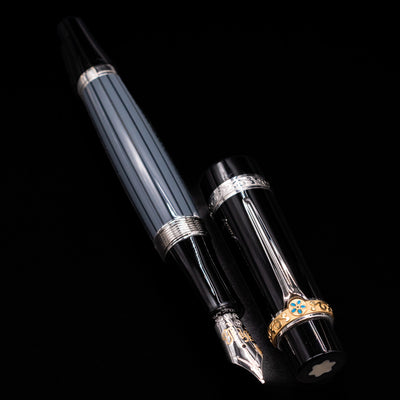 A full view of the Montblanc Writer's Edition Honore de Balzac Fountain Pen - Preowned uncapped, with its cap laying next to the pen. 