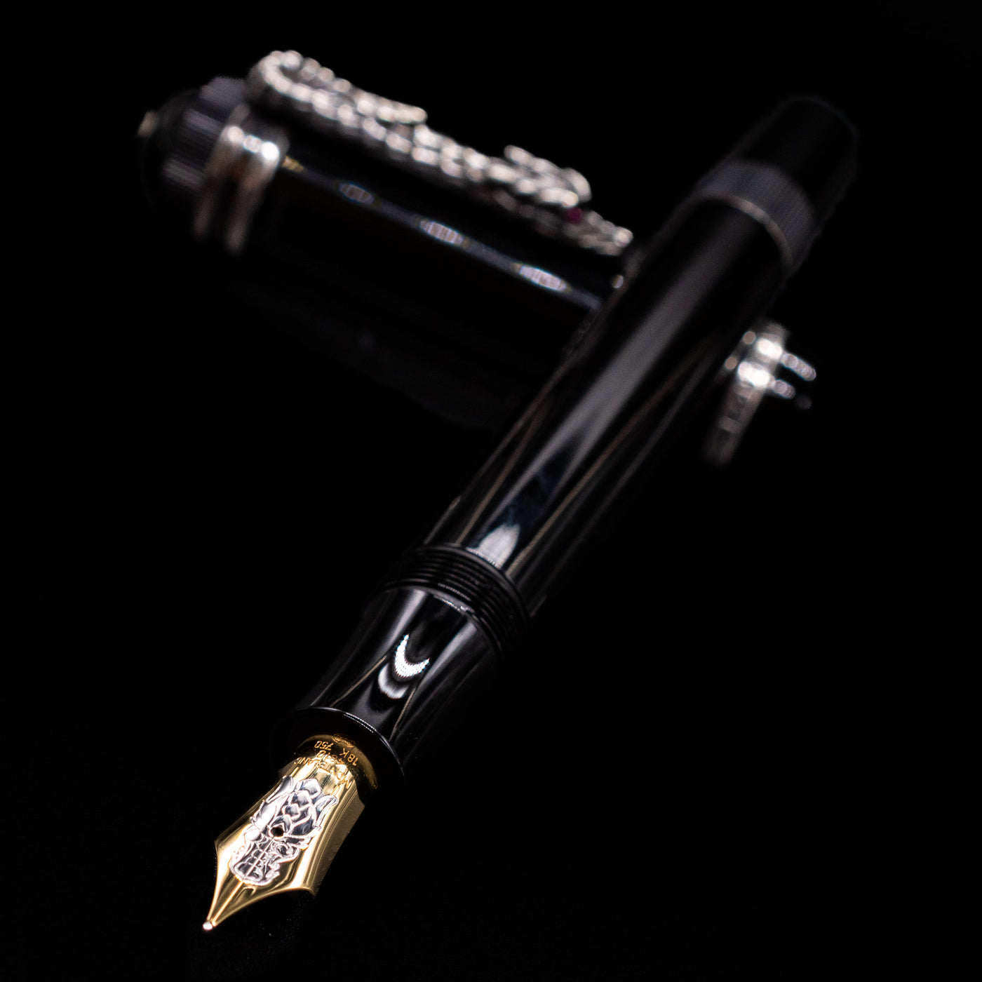 Montblanc Writer's Edition Imperial Dragon 1993 Fountain Pen - Preowned laying across its own cap, crossed, with a focus on the nib.