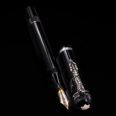 A full view of the Montblanc Writer's Edition Imperial Dragon 1993 Fountain Pen - Preowned uncapped, with its cap laying next to the pen. 