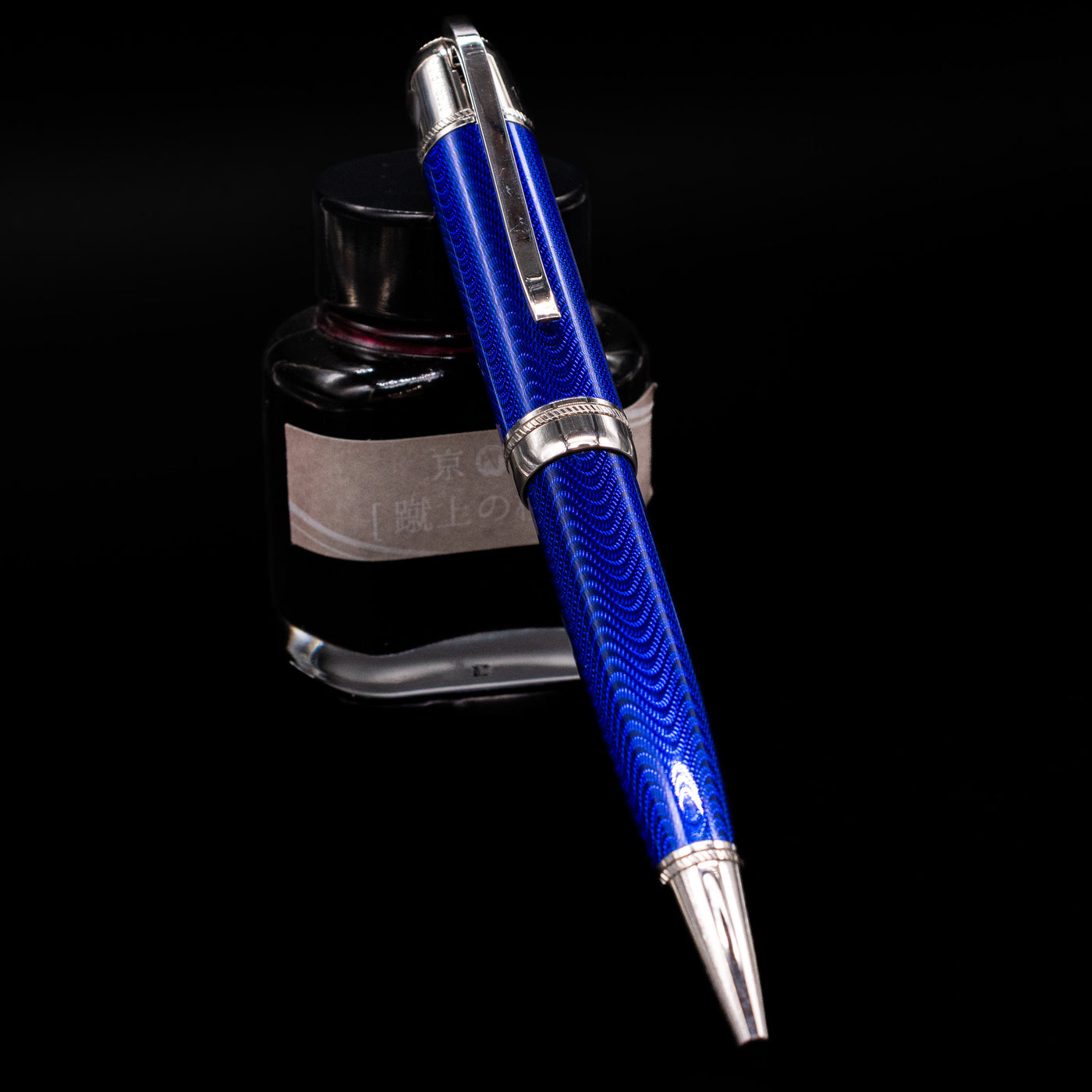 Montblanc Writer's Edition Jules Verne Ballpoint Pen - Preowned leaning against an ink bottle.