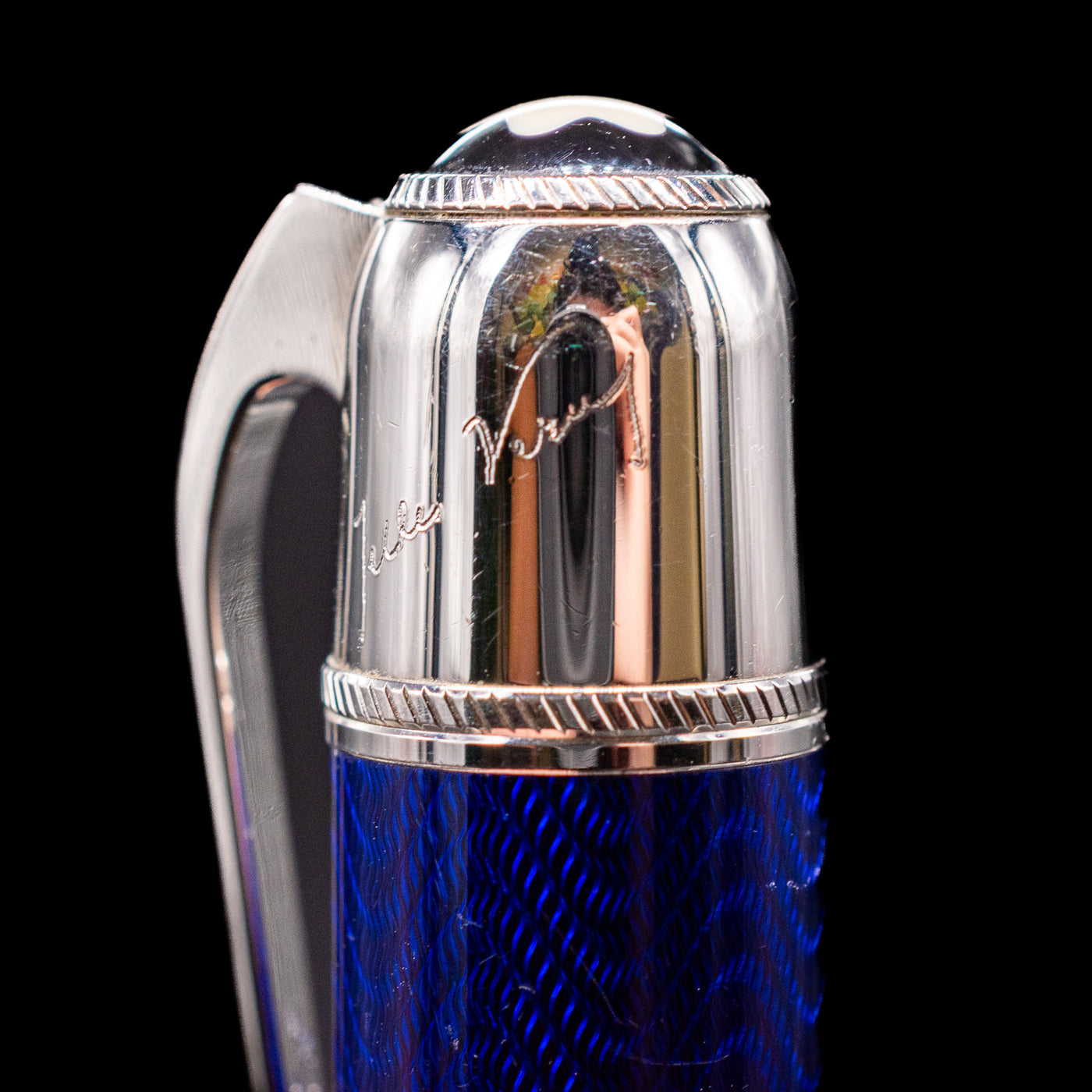 A macro shot of the writer's signature on top of the barrel on the Montblanc Writer's Edition Jules Verne Ballpoint Pen - Preowned.