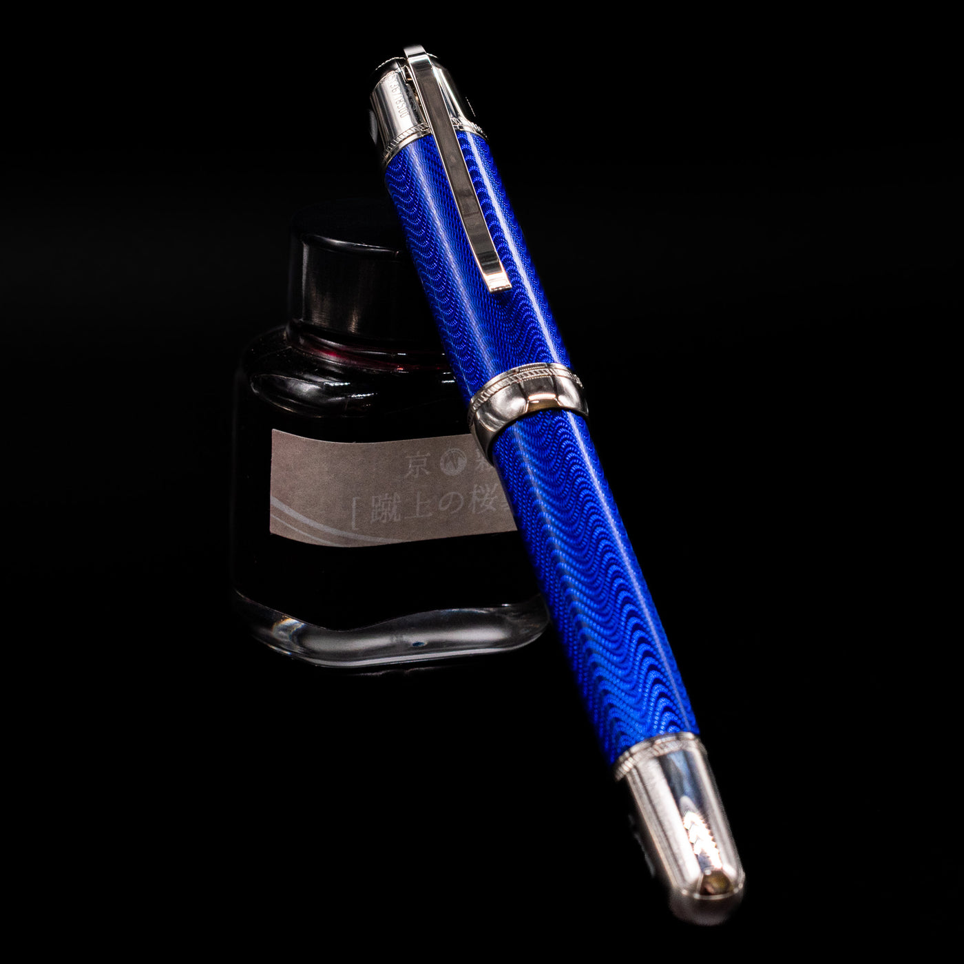 Montblanc Writer's Edition Jules Verne Fountain Pen - Preowned capped, leaning against an ink bottle. 