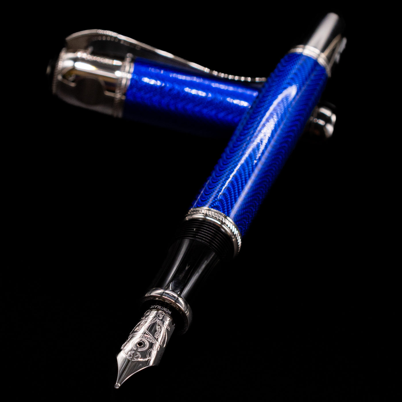 Montblanc Writer's Edition Jules Verne Fountain Pen - Preowned laying across its own cap, crossed, with a focus on the nib.