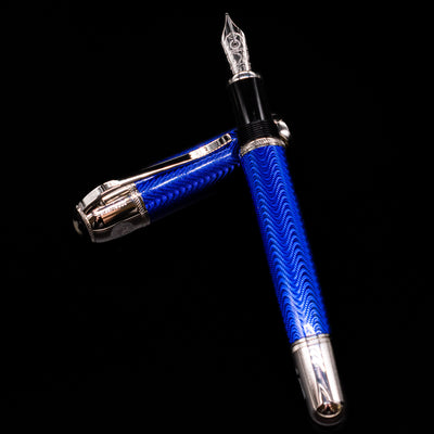 Montblanc Writer's Edition Jules Verne Fountain Pen - Preowned laying on top of its cap in a crossed position showing full view of the entire uncapped pen.