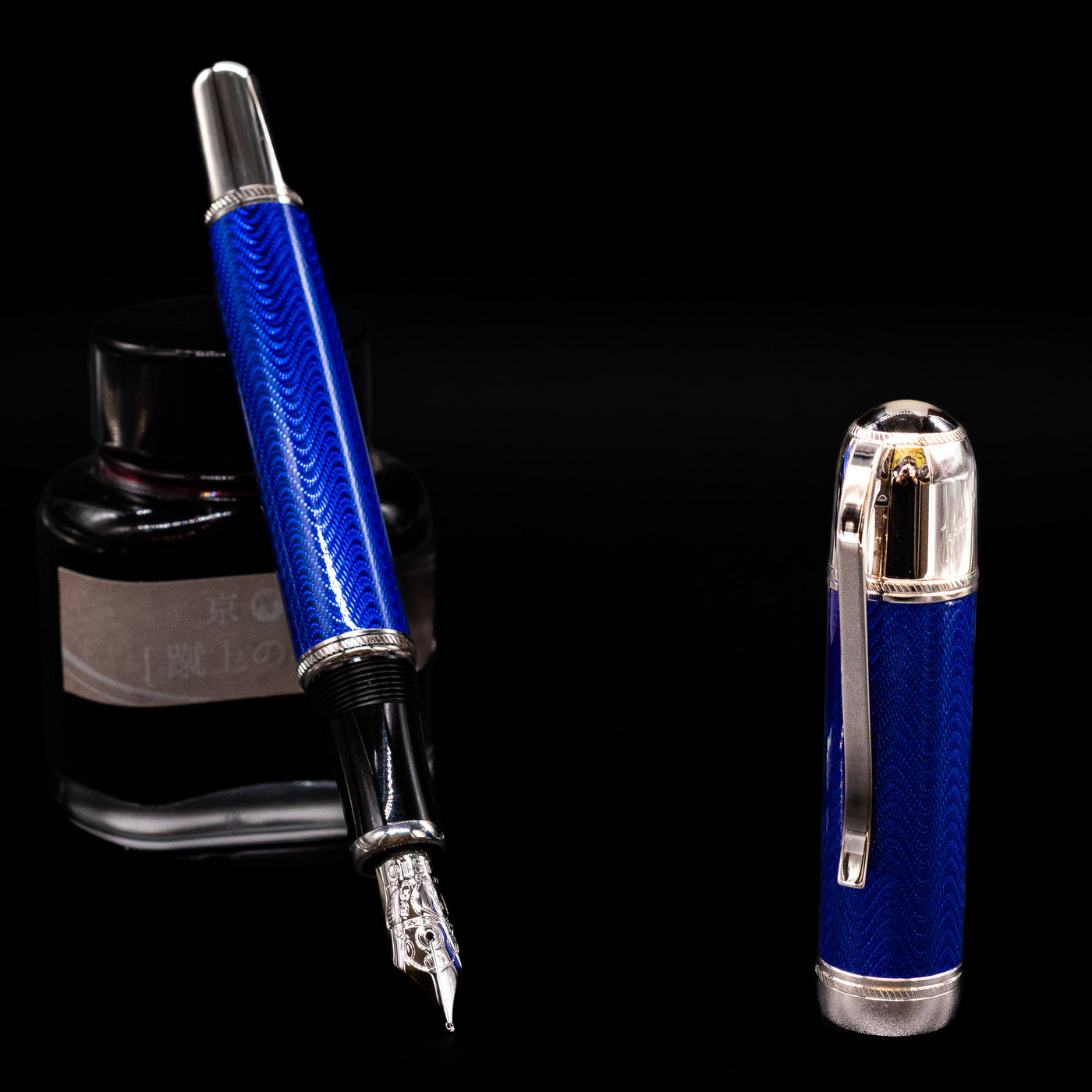 Montblanc Writer's Edition Jules Verne Fountain Pen - Preowned leaning on an ink bottle uncapped showcasing the detailing on the nib.