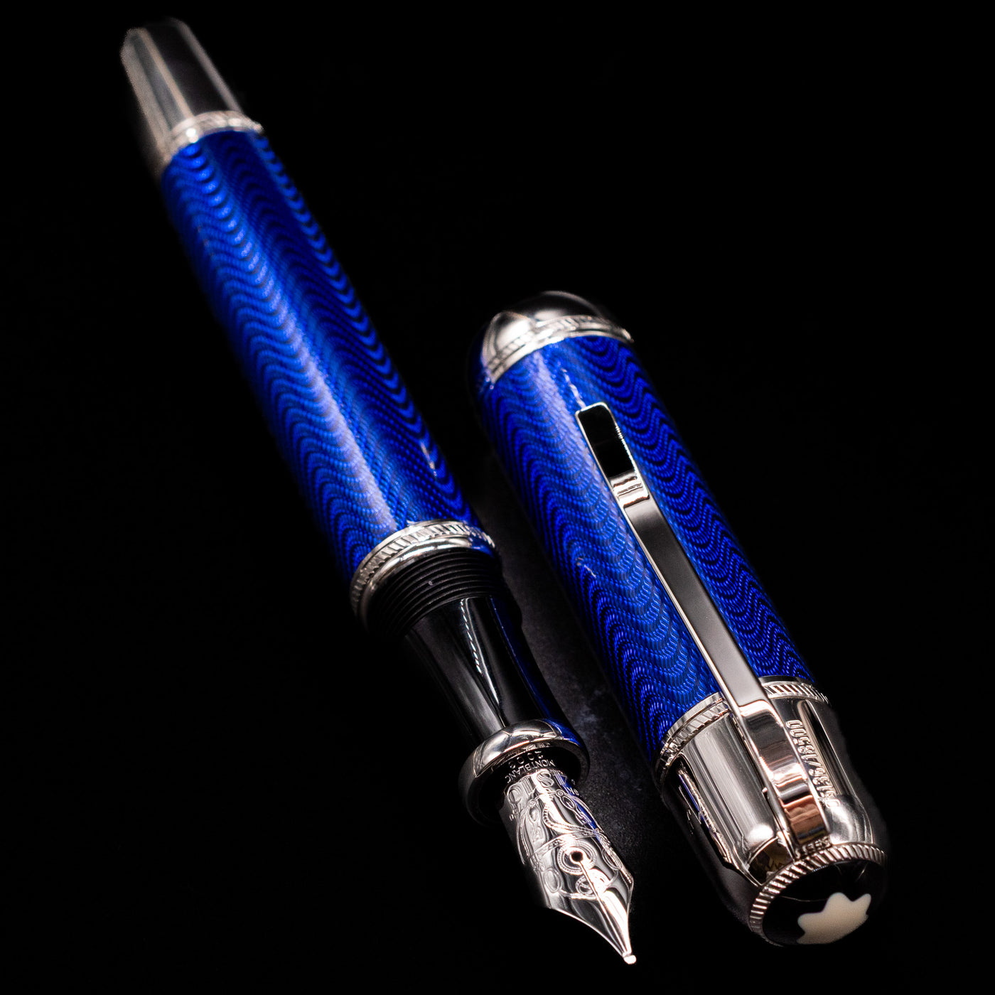 A full view of the Montblanc Writer's Edition Jules Verne Fountain Pen - Preowned uncapped, with its cap laying next to the pen. 