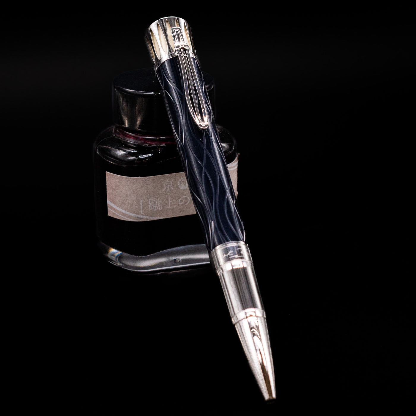 Montblanc Writer's Edition Mark Twain Ballpoint Pen - Preowned leaning against an ink bottle.