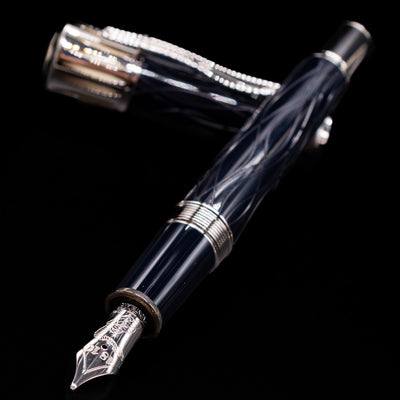 Montblanc Writer's Edition Mark Twain Fountain Pen - Preowned laying across its own cap, crossed, with a focus on the nib.