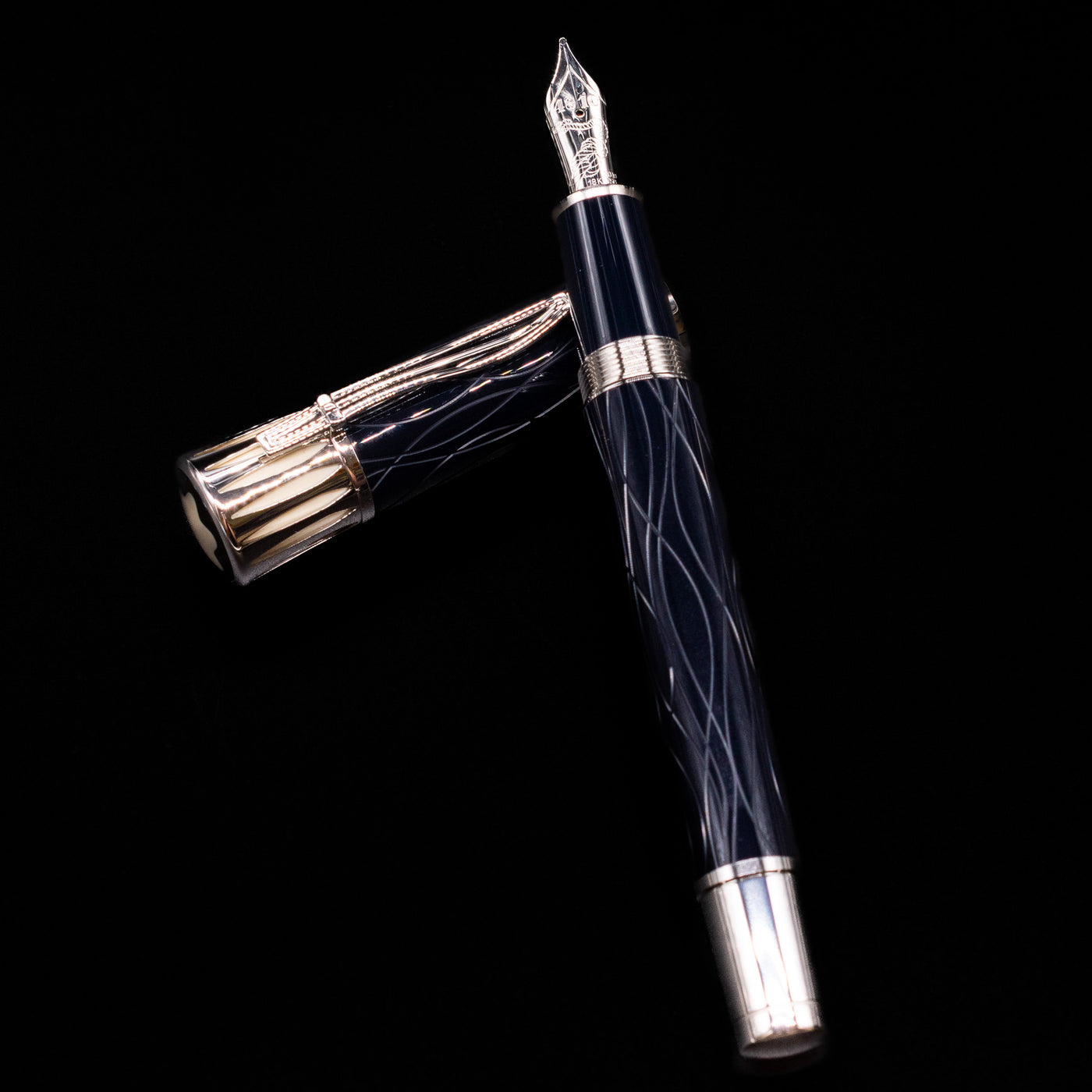 Montblanc Writer's Edition Mark Twain Fountain Pen - Preowned laying on top of its cap in a crossed position showing full view of the entire uncapped pen.
